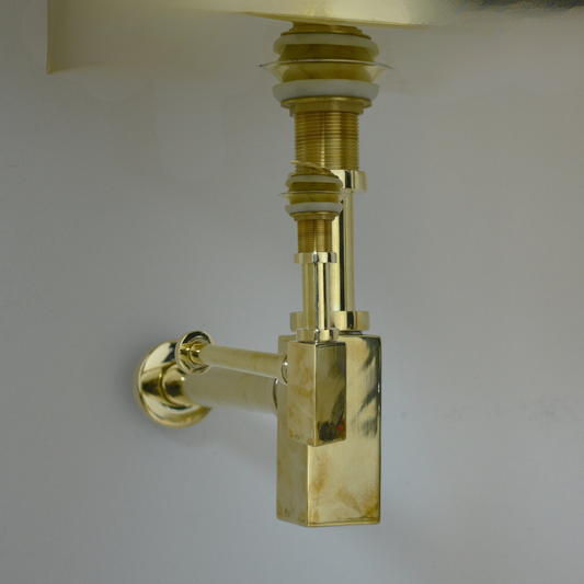 Modern solid brass square bottle trap with a living brass finish