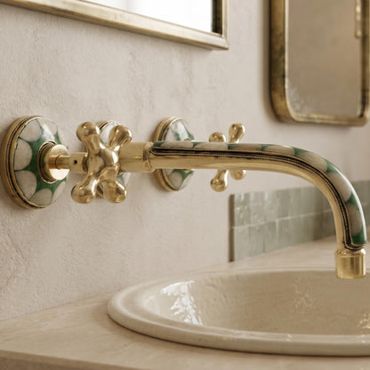 Angled view of Moroccan brass wall faucet with bone inlay
