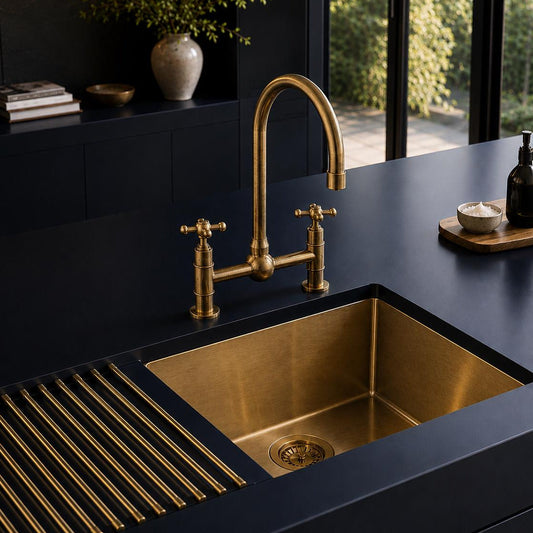 Angled view of unlacquered brass bridge kitchen faucet with cross handles