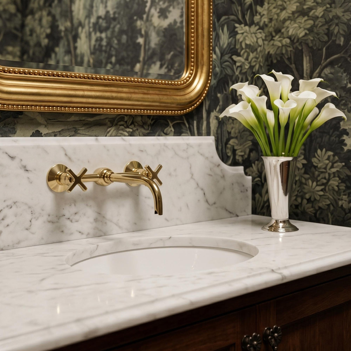 Angled view of unlacquered brass wall faucet with curved spout