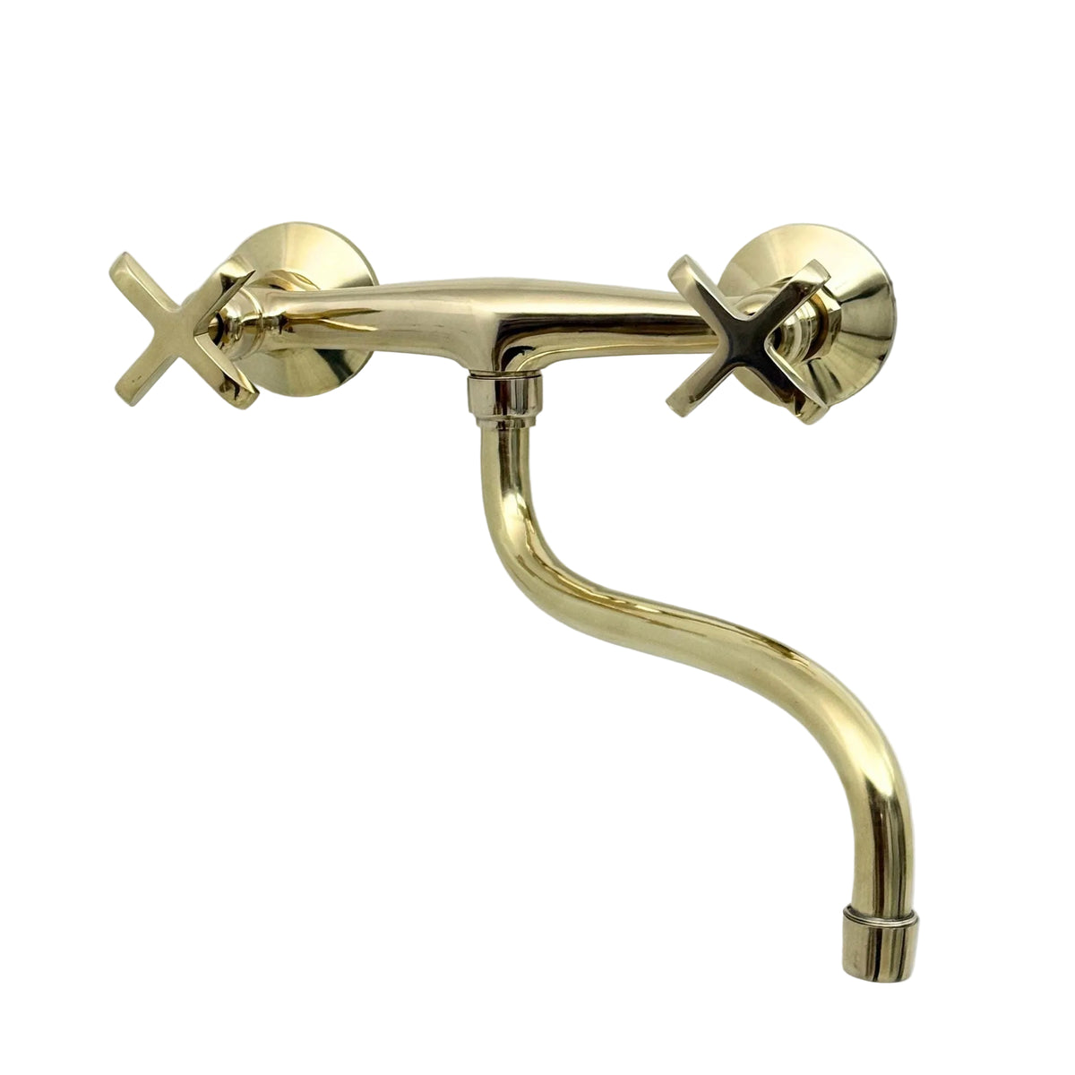 Close-up of cross handles on an unlacquered brass wall faucet