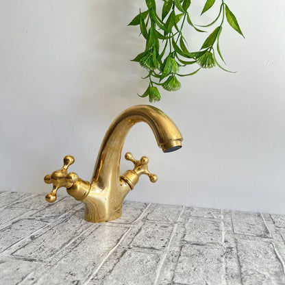 Close-up of handcrafted details on a traditional brass faucet