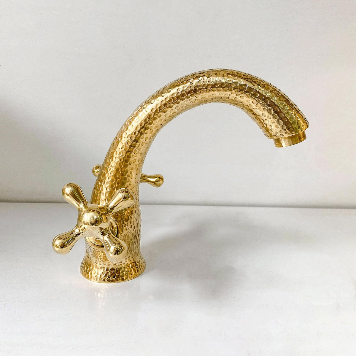 Close-up of the unlacquered brass finish and cross handle details