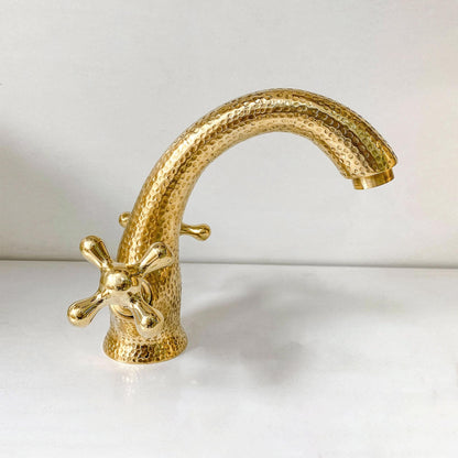 Close-up of the unlacquered brass finish and cross handle details