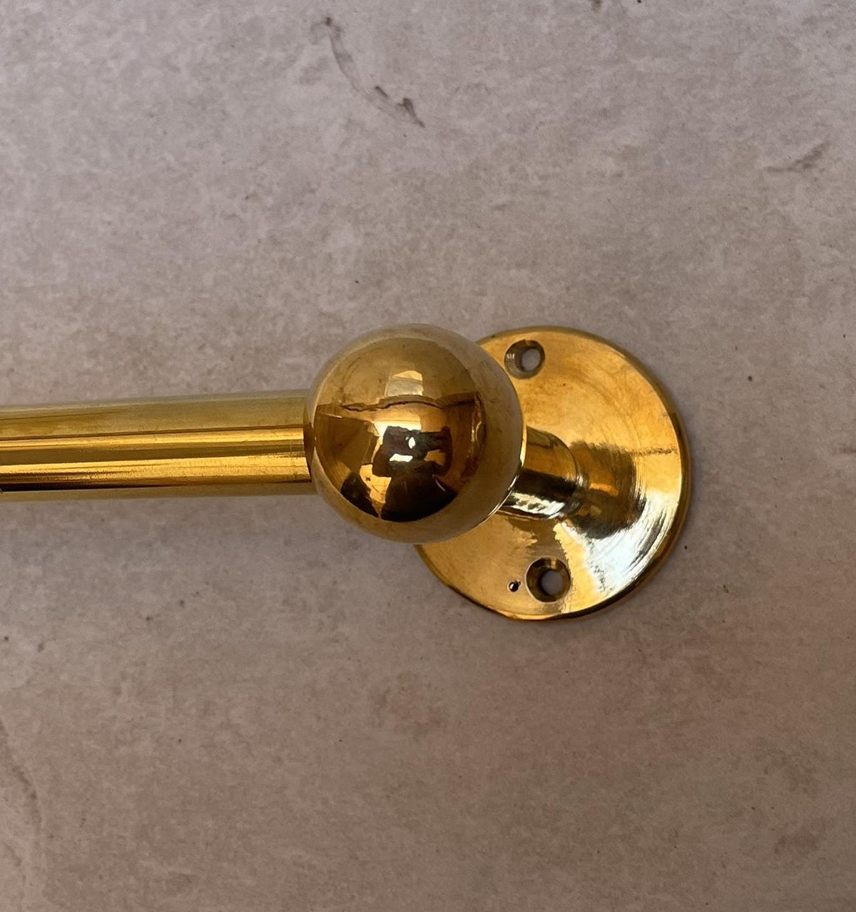 Elegant unlacquered brass towel rail with a natural aging finish