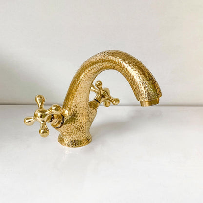 Front view of handcrafted unlacquered brass bathroom faucet with cross handles