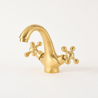 Front view of handcrafted unlacquered brass widespread bathroom faucet with cross handles
