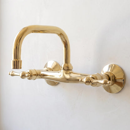 Luxury unlacquered brass bathroom faucet with traditional lever handles