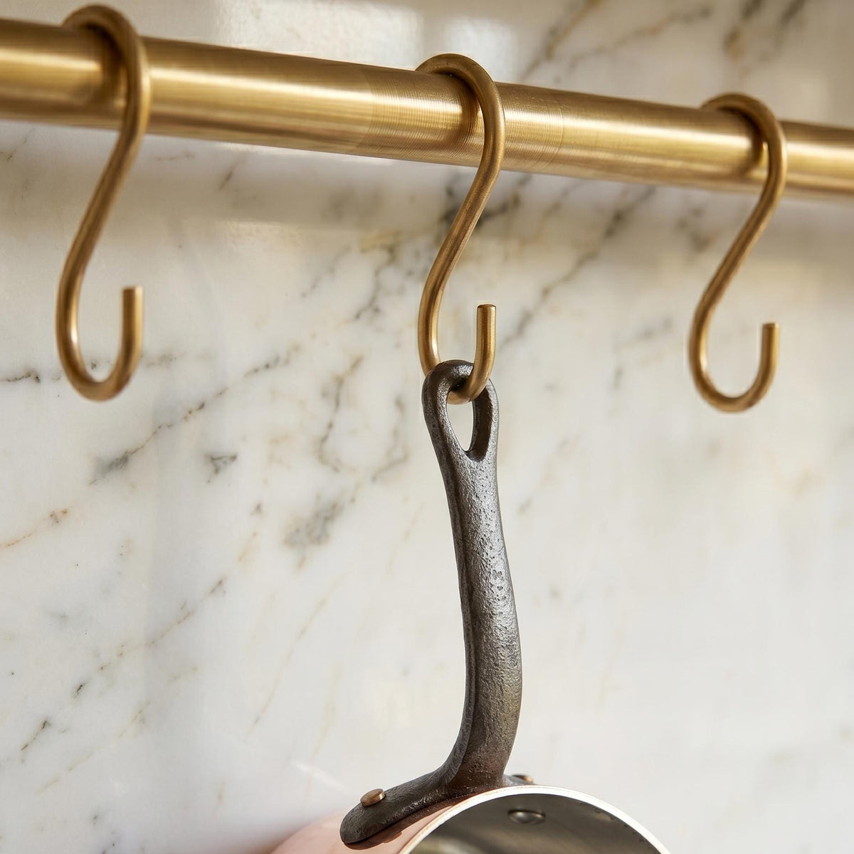 Matching solid brass S-hooks on wall mount kitchen rail