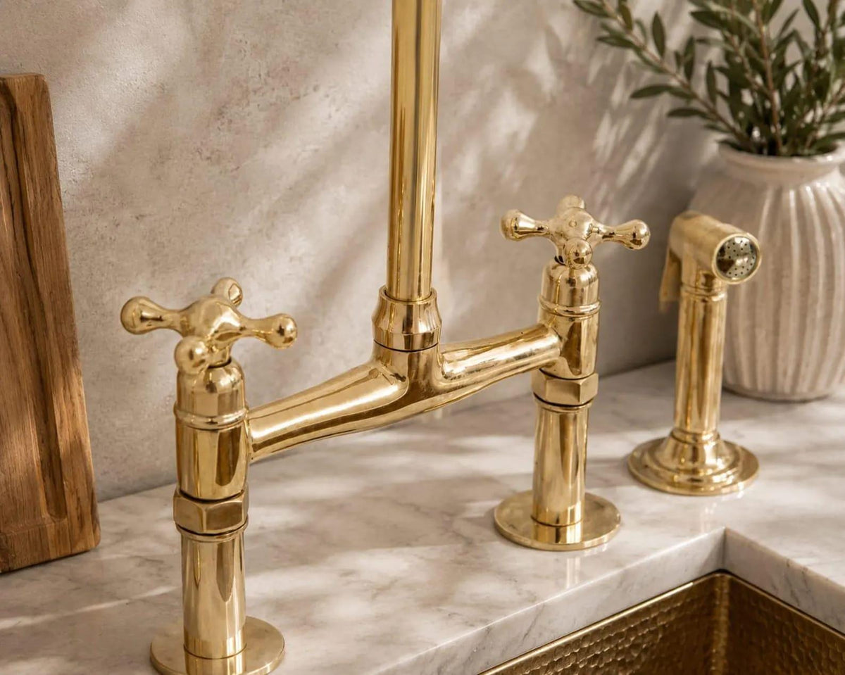 Side sprayer detail on a handcrafted brass bridge faucet