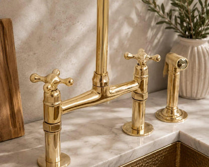 Side sprayer detail on a handcrafted brass bridge faucet