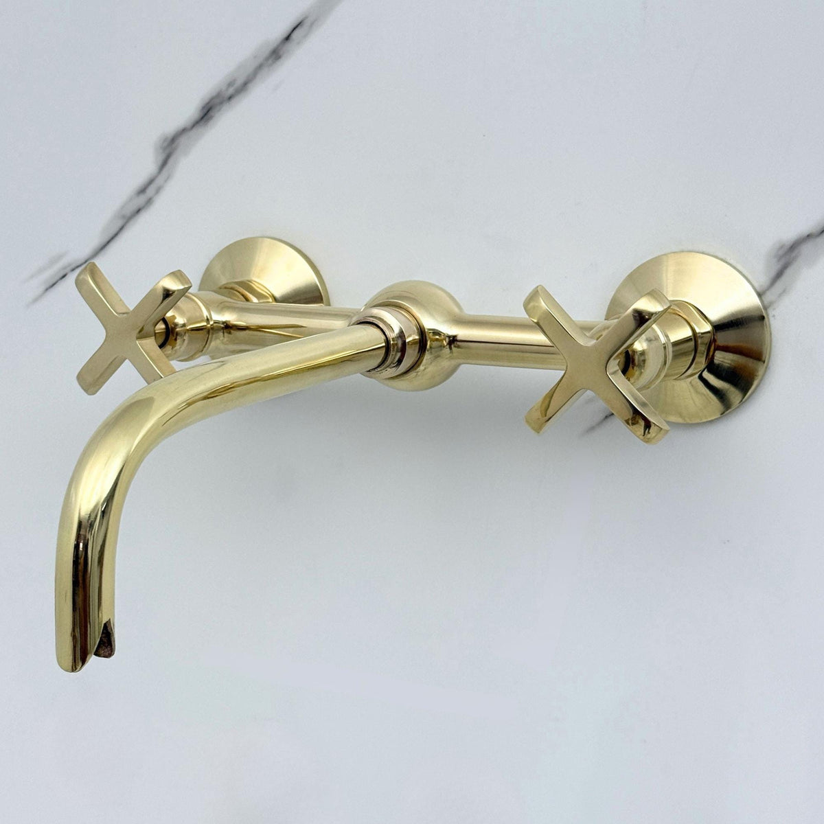 Sleek curved spout on solid brass wall mount faucet