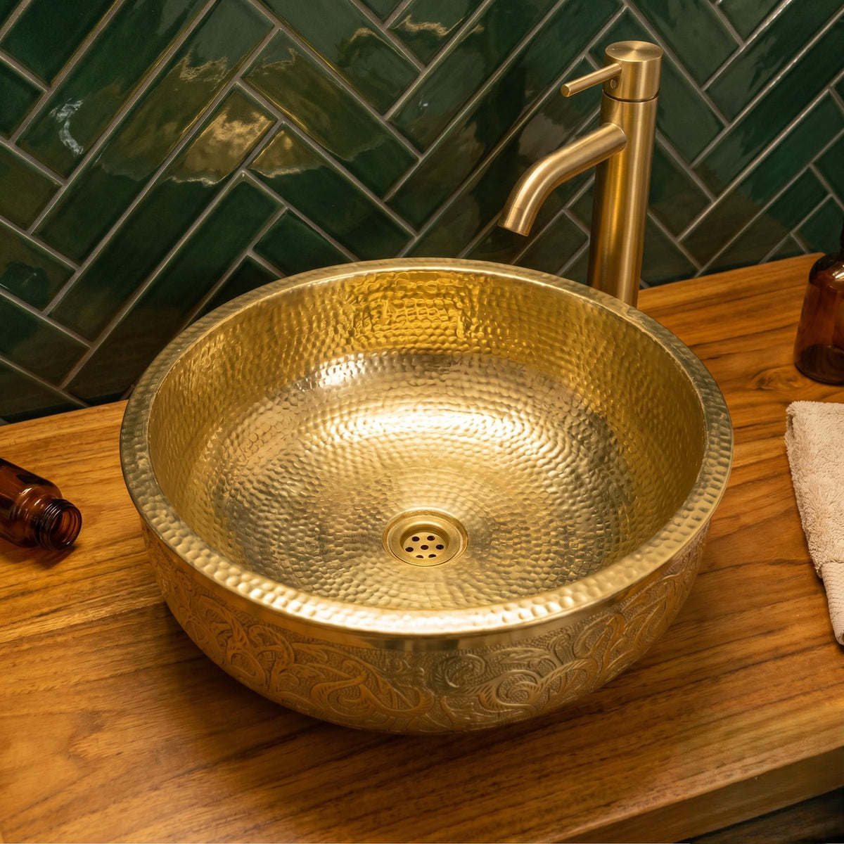 Solid brass bathroom basin with intricate floral engravings