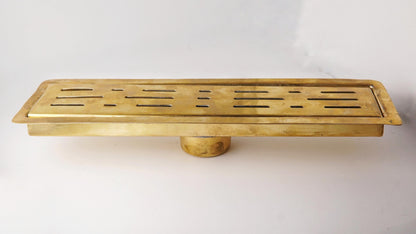 Solid brass linear floor drain with a living brass finish