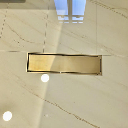 Solid brass linear floor drain with a natural living finish