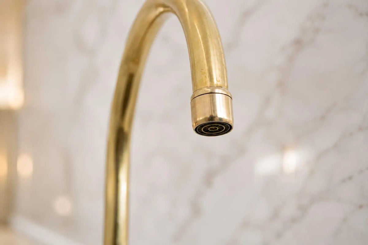 Unlacquered brass bridge faucet with a living finish