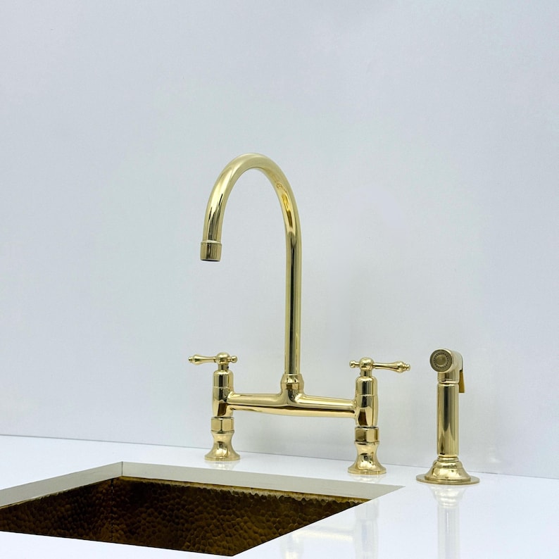 Unlacquered brass bridge faucet with living finish