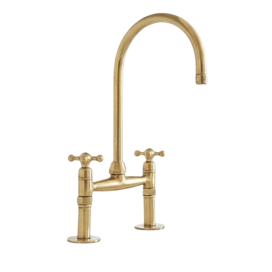 Unlacquered brass bridge kitchen faucet with a side sprayer