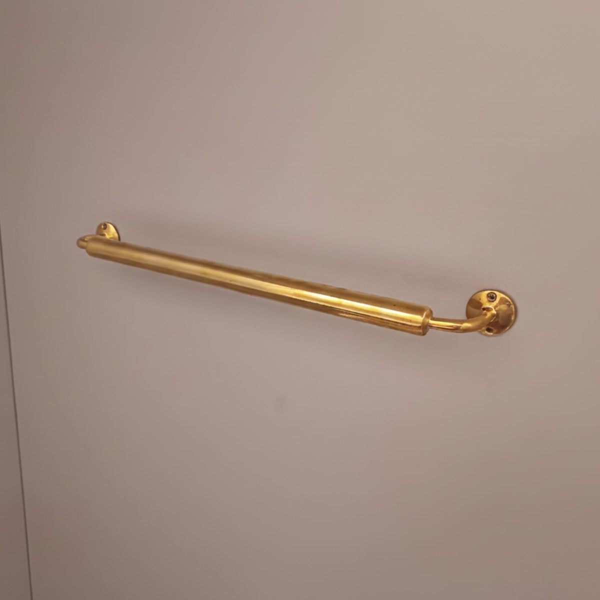 Vintage brass towel rod with a natural living brass finish