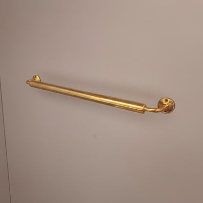 Vintage brass towel rod with a natural living brass finish