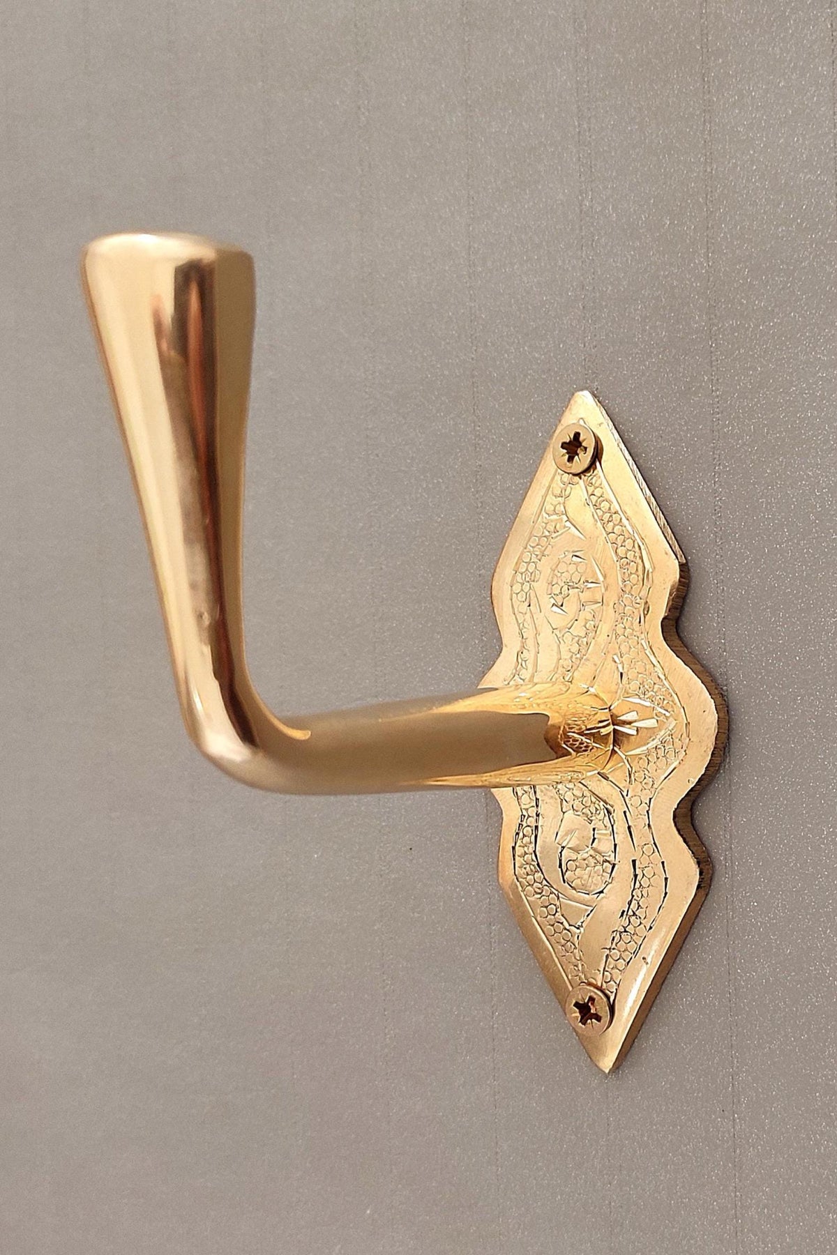 Wall mounted brass hook for coats, hats, and bags