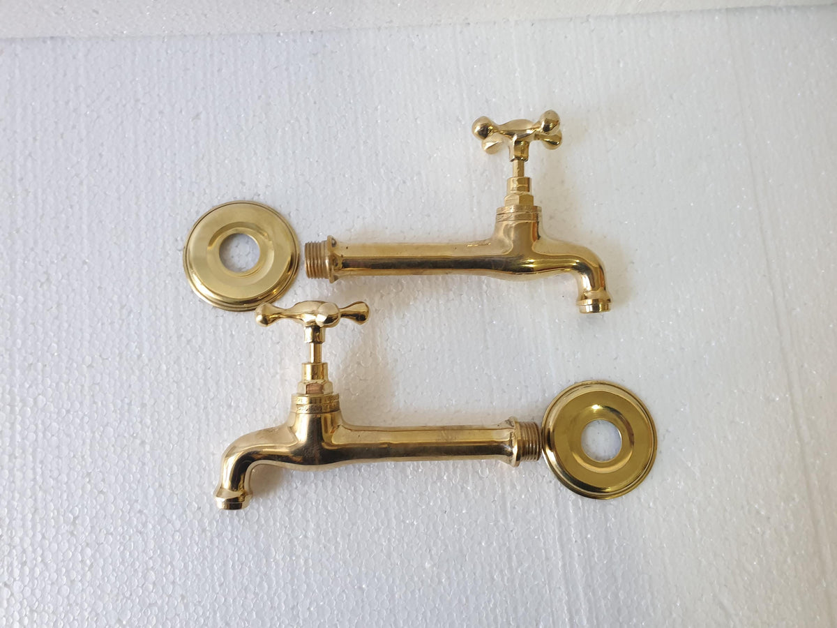 Close-up of handmade brass wall faucet spout outlet