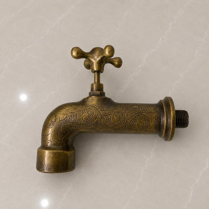 Close-up of hand-engraved detailing on solid brass wall faucet