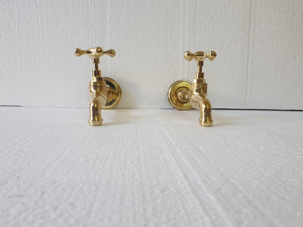 Unlacquered brass patina finish on handmade wall faucet