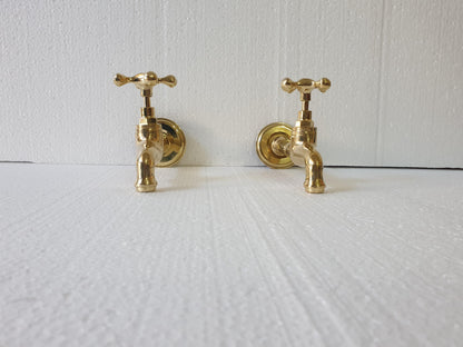 Unlacquered brass patina finish on handmade wall faucet